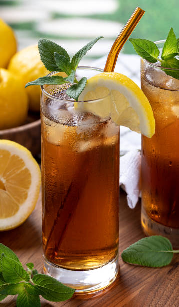 istock Glass of cold ice tea on wooden table 1401150809