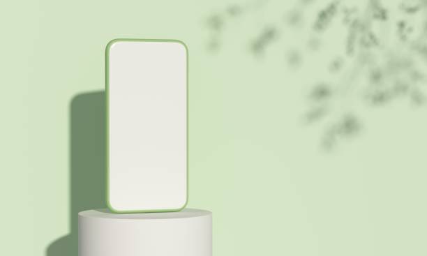 istock Smartphone on Platform podium with natural light on green background.Ecological products concept. 1401152336