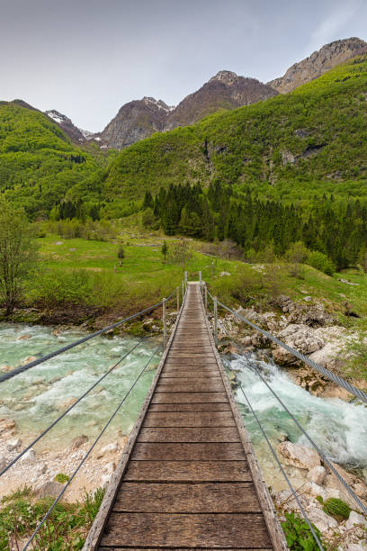 bridge over Soca River in Slovenia View of bridge over the Soca River and mountains in Slovenia soca valley stock pictures, royalty-free photos & images