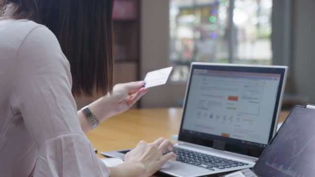 Female office worker doing an online hotel reservation by fulfilling a personal information on website form, online banking shopping and lifestyle, surfing on internet, wireless convenient technology