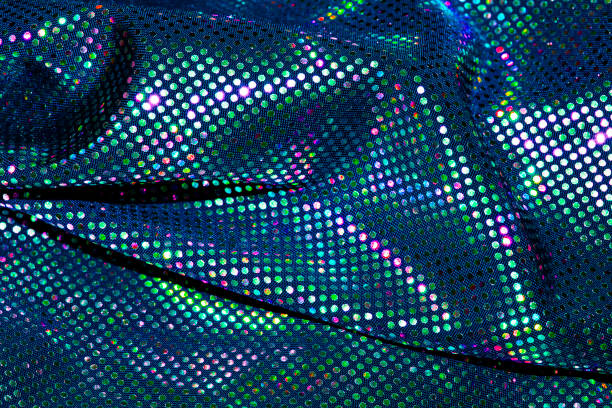 istock Coloured Shiny Sequins on fabric close up abstract background 1401157015