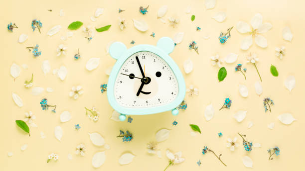 istock Summer flat composition with flowers and children alarm clock 1401157417