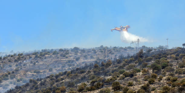 Athens, Greece, June 4, 2022: A firefighting Canadair CL-215 aircraft operates in Hymettus mount wildfire near Glyfada suburb of Athens.