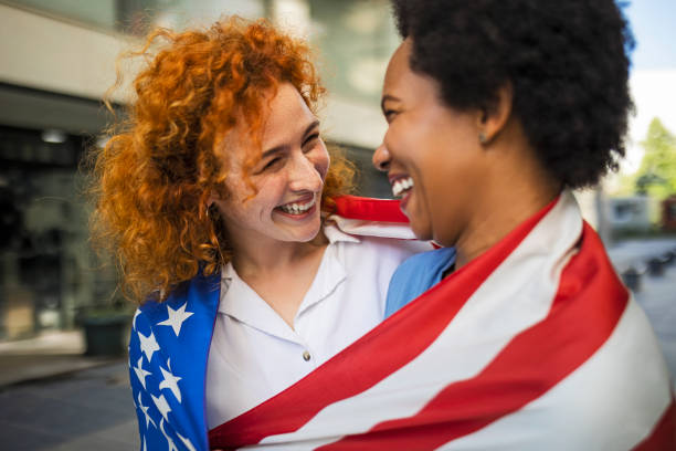 istock Girlfriends celebrating the 4th of July looking at each other 1401161793