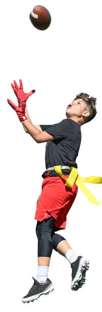 Young boy (child) in a uniform playing in a youth flag football game
