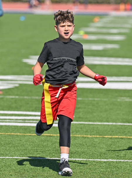 istock Young Athletic Boy Playing Flag Football 1401164347