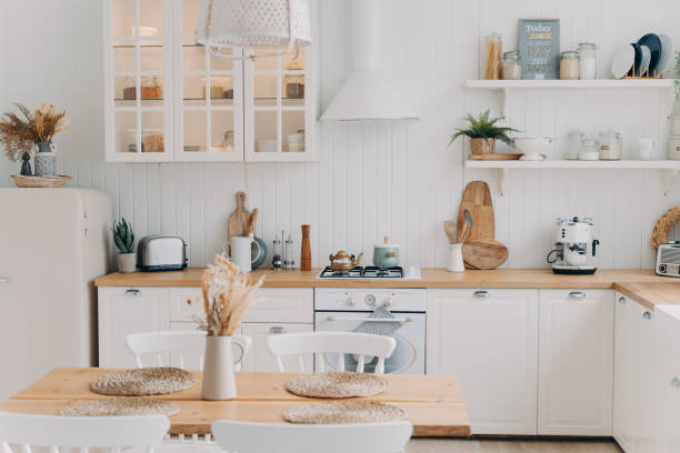 istock Scandinavian kitchen design. Modern dining room decoration. White luxurious interior and appliance. 1401166717