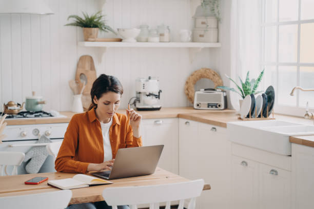 istock Female sales manager is working from home. Lady freelancer with laptop is taking notes. 1401166737
