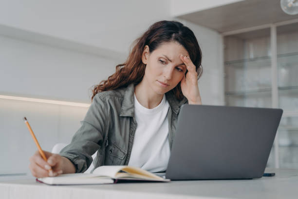 istock Overworked spanish lady has got a headache. Sick tired freelancer is working on laptop at home. 1401166779