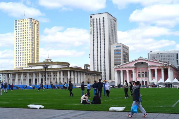 Ulaanbaatar, Mongolia - 11 May 2022: young Mongolian people rest and communicate with each other on a football field in the centre of Sukhbaatar square