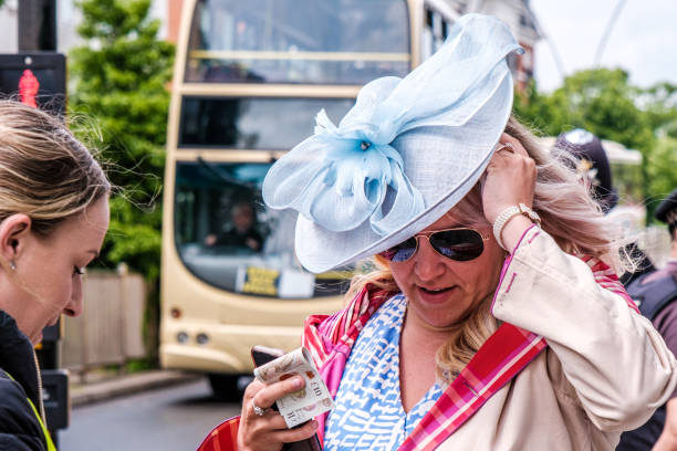 mujer con un sombrero turquesa blue fascinator comprando un boleto - people personal accessory town hat fotografías e imágenes de stock