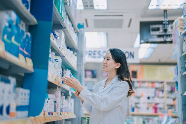 istock Asian Chinese Pharmacist checking inventory at shelf in retail pharmacy 1401172684