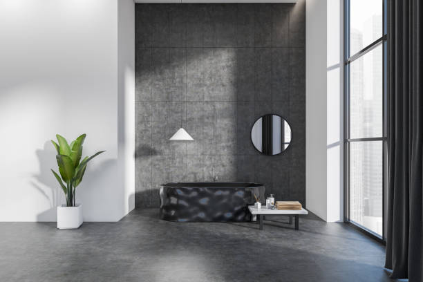 istock Grey bathroom interior with tub, table with accessories and panoramic window 1401173420