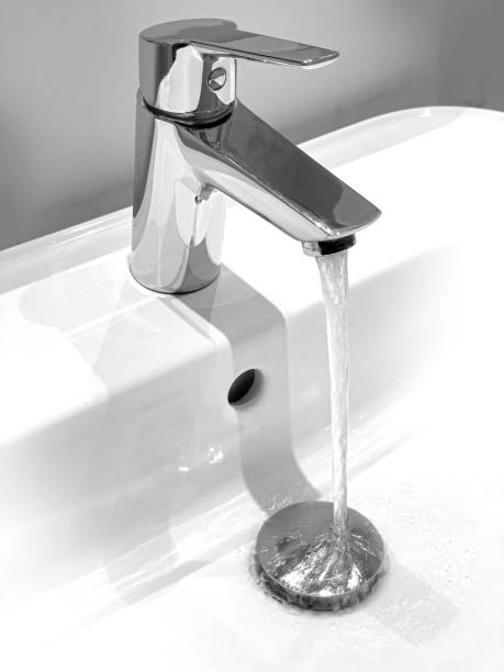 istock Faucet and water drop close up. 1401174869