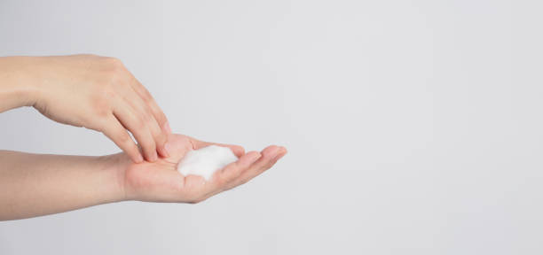 istock Hands washing gesture with foaming hand soap on white background. 1401178380