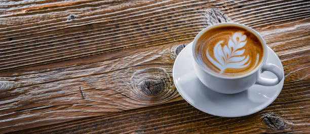 istock A cup of coffee on an old wooden table. 1401178485