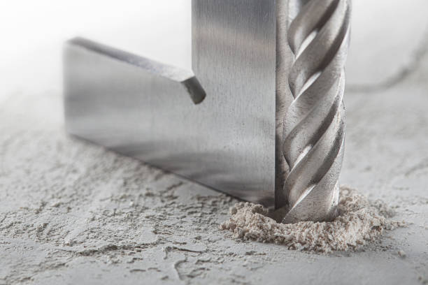 istock drill bit make holes in concrete wall with steel triangle. Building work industry. 1401178880