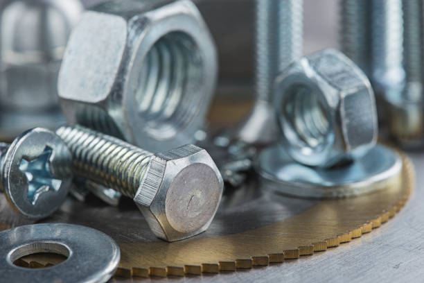 istock set of different nuts, bolts, screws, washers and drill bits,thread tap and mill cutters on steel plate background. Locksmithing deal. 1401178883