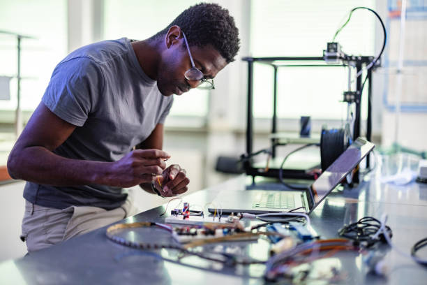 istock African-American Technician Repairing A 3D Printer In Laboratory 1401178931