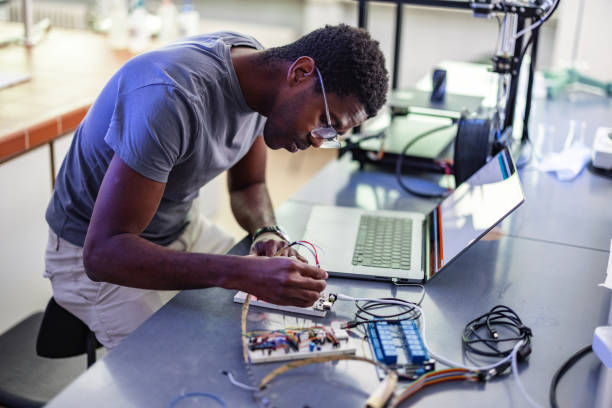istock African-American Technician Repairing A 3D Printer In Laboratory 1401178933