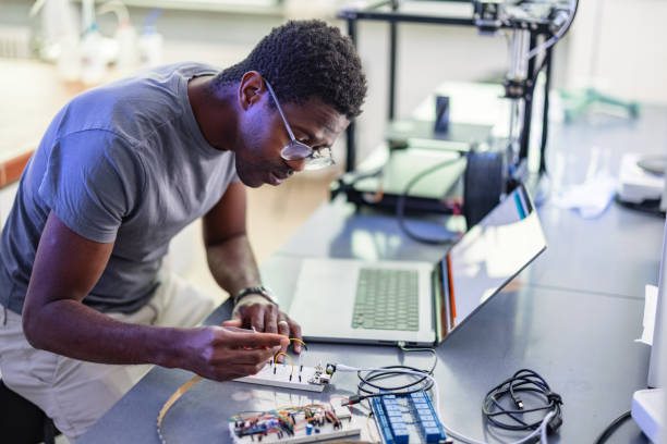 istock African-American Technician Repairing A 3D Printer In Laboratory 1401178992