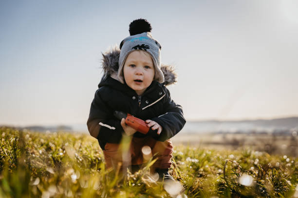 istock Little boy playing with toy on green meadow 1401180258