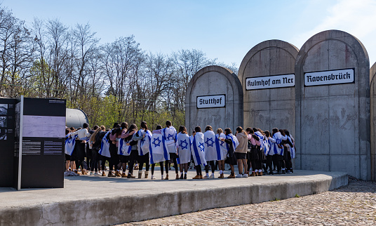 Łódź, Poland - May 2, 2022: A picture of the historic Radegast train station, and its concentration camp memorial, while a class of Jewish students visits.