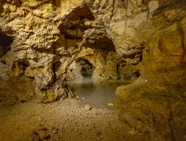 Scenic view of cave over lake Scenic view of underground cave over lake natural pattern pattern nature rock stock pictures, royalty-free photos & images