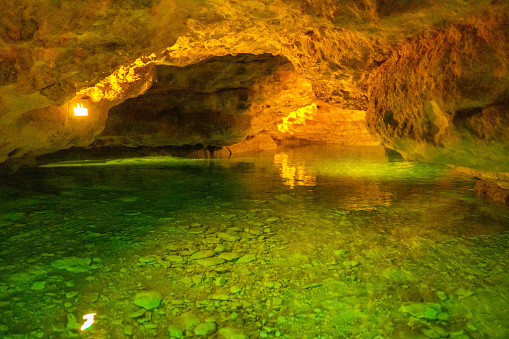 Scenic view of illuminated underground cave and lake