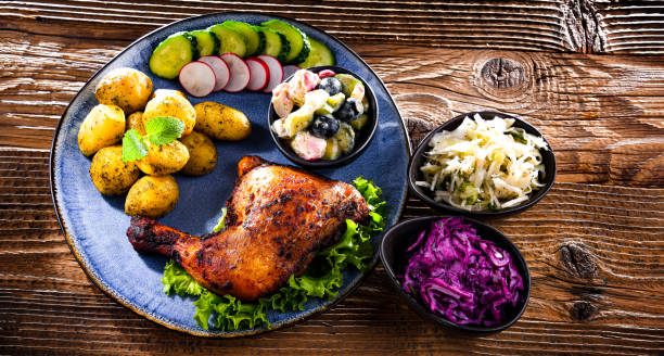 istock Baked chicken leg with potatoes and vegetable salads 1401180620