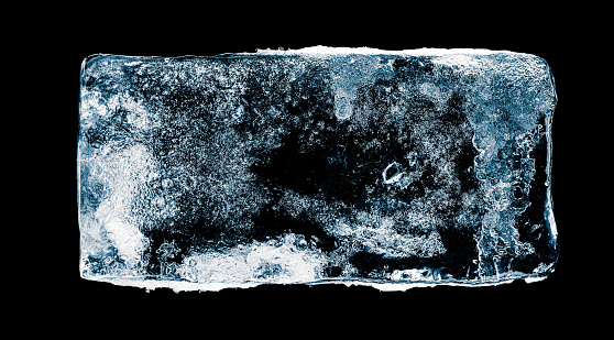 Textured, rectangular ice block, isolated on black background. Clipping path included.