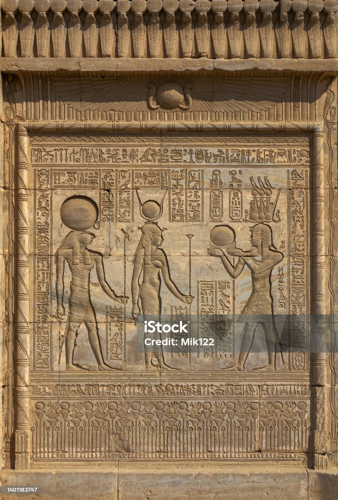 Hieroglyphic carvings in ancient egyptian temple Hieroglyphic carvings on the exterior walls of an ancient egyptian temple Hieroglyphics Stock Photo