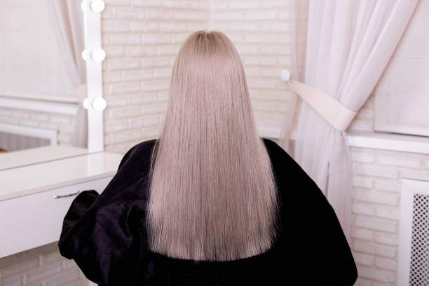 istock Female back with long, straight, blonde hair 1401184851