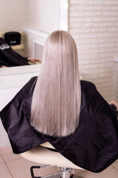 istock Female back with long, straight, blonde hair 1401184853