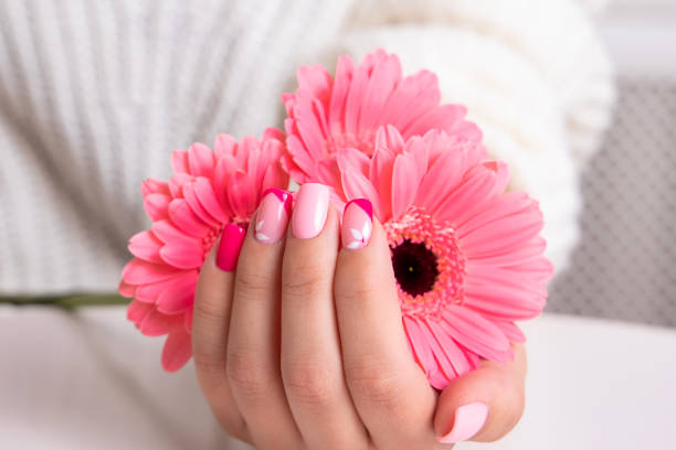 istock Female hands with pink manicure, flowers design 1401185487