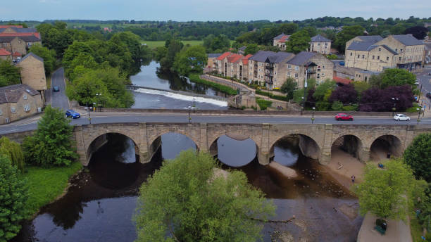 Aerial view of road bridge crossing River Wharfe at Wetherby, West Yorkshire, England, Britain Drone point of view of old bridge across river with traffic river wharfe stock pictures, royalty-free photos & images