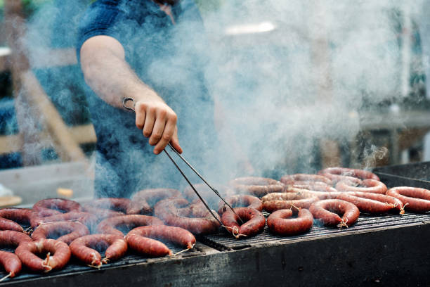 istock Cook grilling sausages 1401187859
