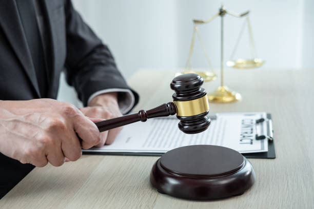istock Male lawyer working with legal case document contract in office 1401188254