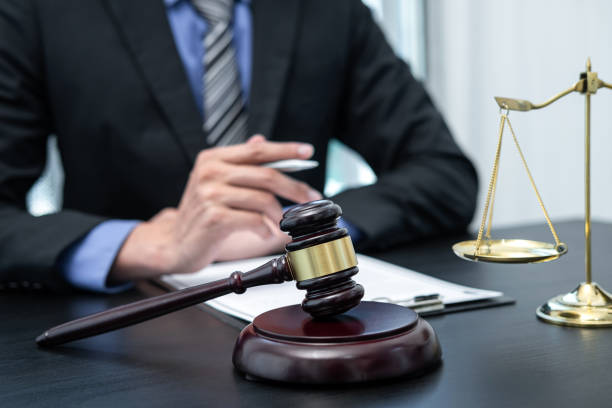 istock Male lawyer working with legal case document contract in office 1401188342