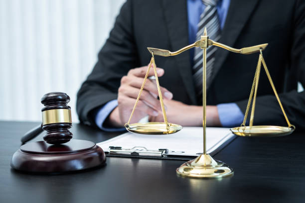 istock Male lawyer working with legal case document contract in office 1401188352