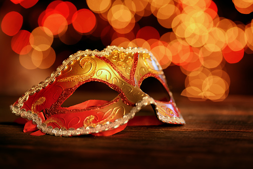Traditional carnival mask over holiday lights  background