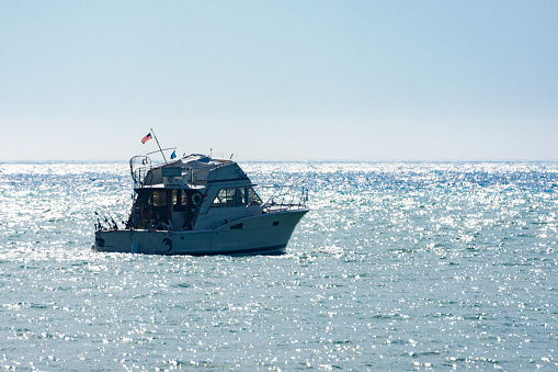 A fishing charter boat heads out onto Lake Michigan on a chilly summer's morning near Port Washington, Wisconsin.