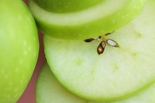 Sliced green Granny Smith apple. Apple seeds