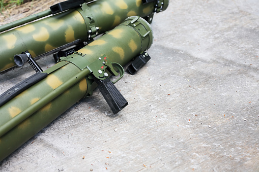 Pair of modern rocket propelled grenades on gray background with free space