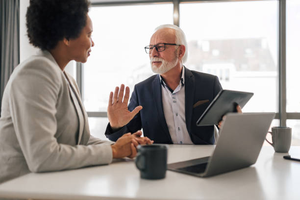 istock Elderly professional planning business strategy with partner over digital tablet 1401199820