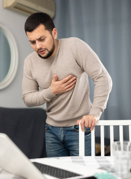 istock Man experiencing chest pain after working long hours on laptop 1401200498