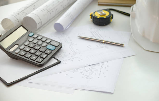 istock Construction drawings with tools on wooden table isolated on white background 1401201952