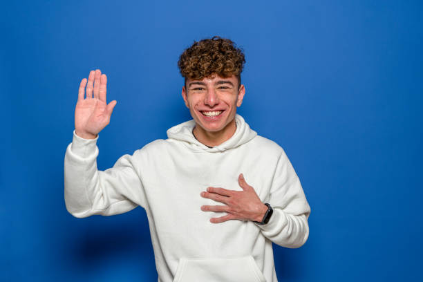 istock Young man isolated on blue background taking an oath, putting hand on chest 1401204744