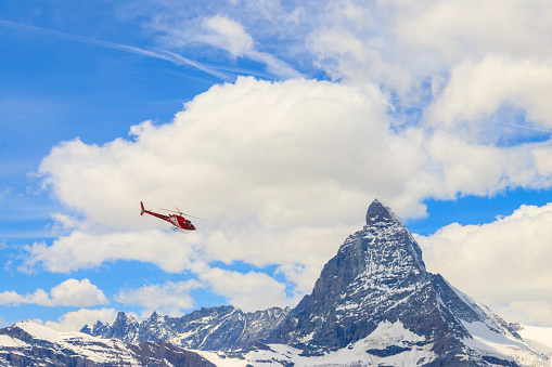 Helicopter flying over snowy Matterhorn peak, Switzerland