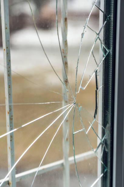 istock Glass broken by hooligans in a metal-plastic window, close-up 1401209052